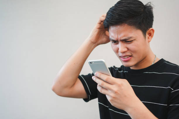 A Man Having Trouble Looking at his Smartphone