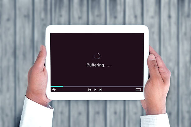 A Hand of a Person is Holding a Tablet that is currently Buffering