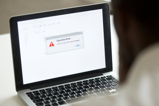 Man in Front of a Laptop with a screen of Operation Error