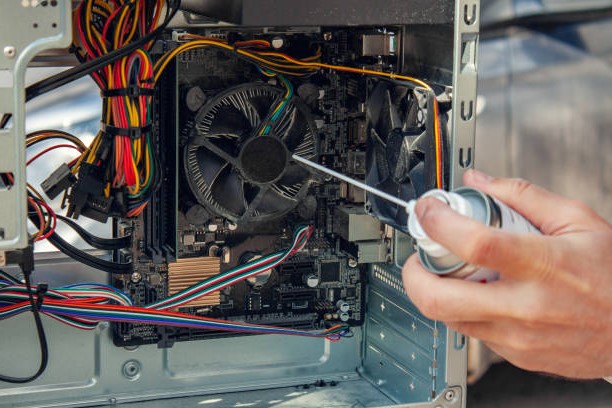 A Person Cleaning inside of a Computer