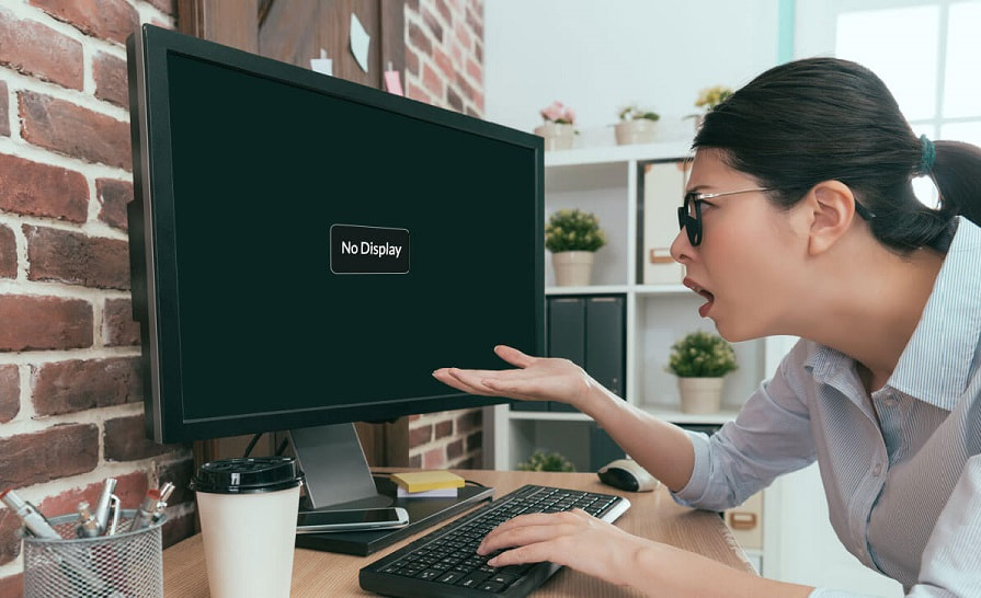 A Woman having Trouble with his Computer Monitor that has No Display