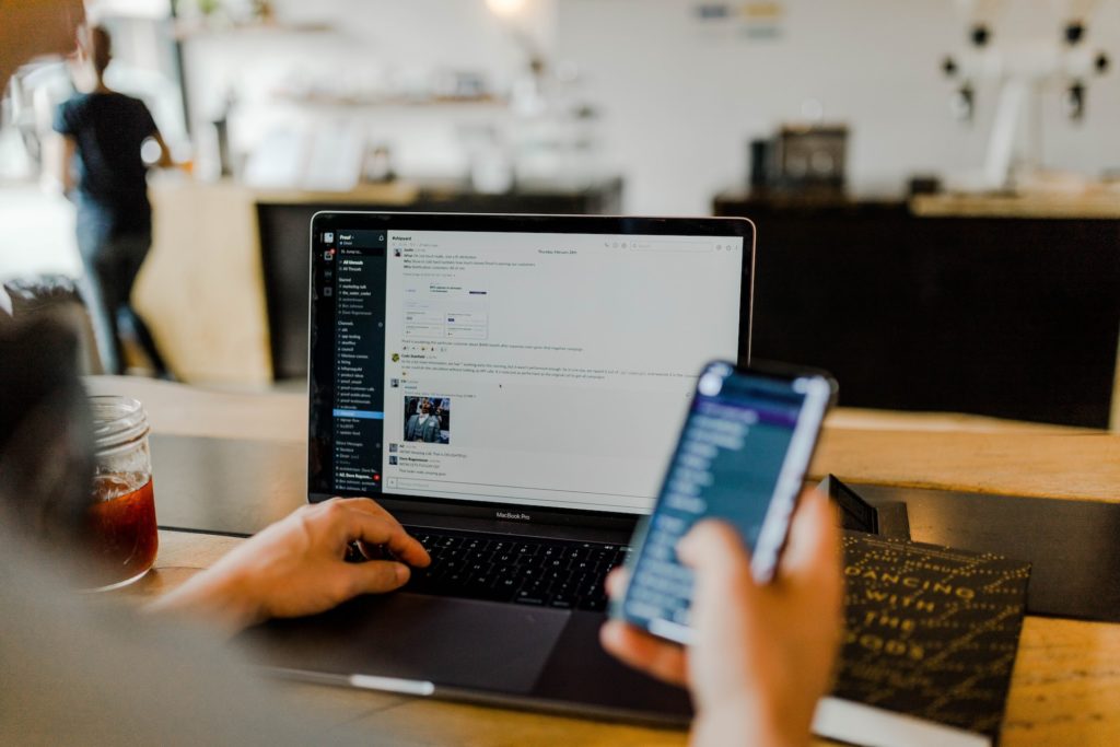 A Person using a Laptop and Smartphone Software as a Service