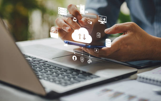 A Businessman using Cloud Software on his Phone and Laptop