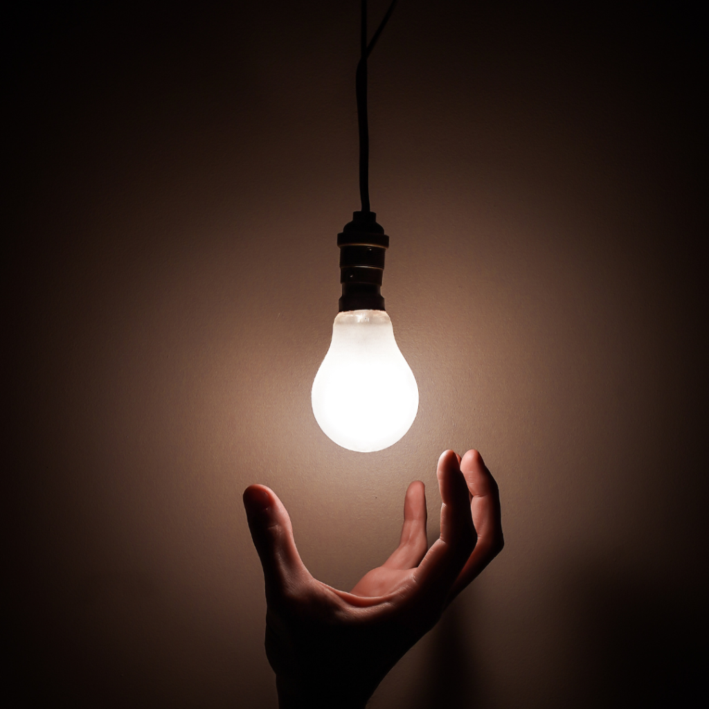 A Person reaching for the Light Bulb