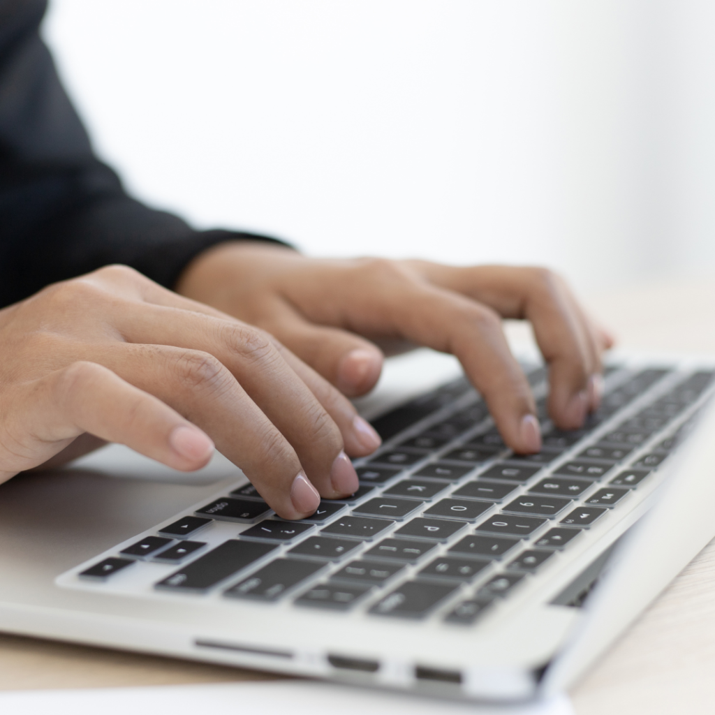 A Person on his Laptop Typing on his Keyboard